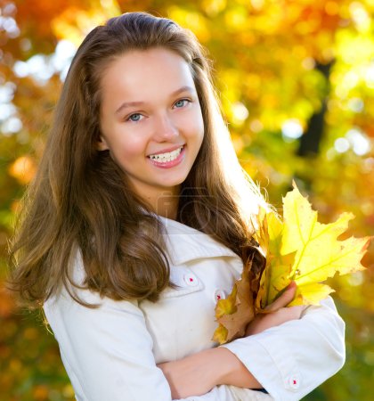 Beautiful Teenage Girl in autumn park