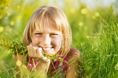Beautiful Summer Portrait Of Little Girl In The Grass
