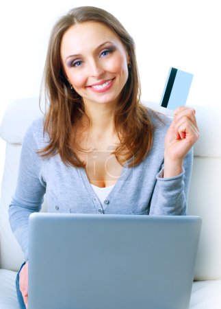 Smiling Woman shopping online with credit card and computer.Inte