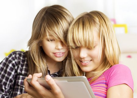 Teenage girls using touchpad. PC tablet