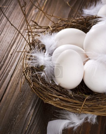 Easter Eggs in the nest over wooden background