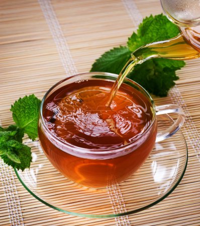 Pouring Healthy Tea With Mint