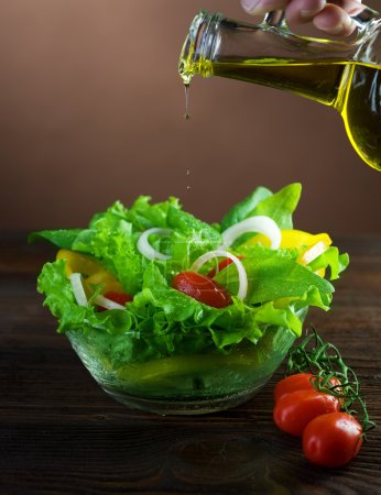 Healthy Salad And Pouring Olive Oil