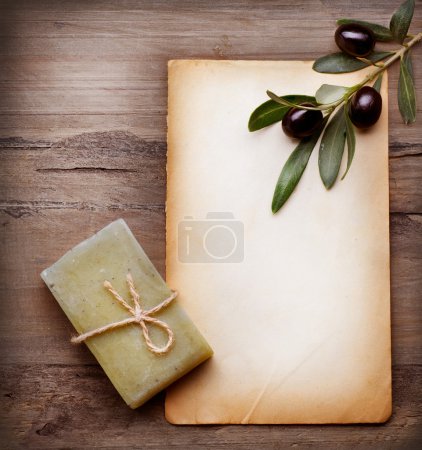Handmade Olive Soap and Blank Paper with Olive Branch over Woode