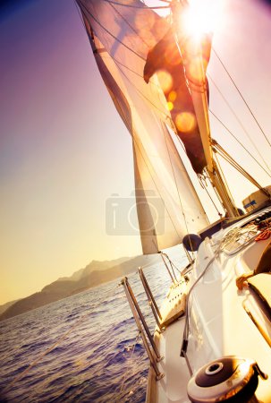 Yacht Sailing against sunset.Sailboat.Sepia toned