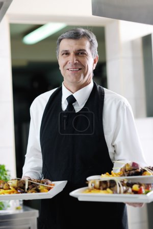 Male chef presenting food