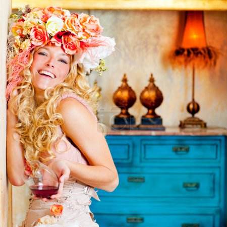 Baroque fashion blond womand drinking red wine