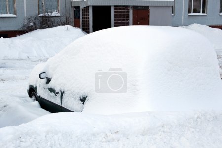 Car covered by big amount of snow