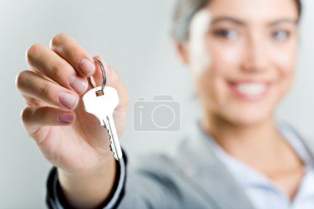 Happy woman's hand holding new key