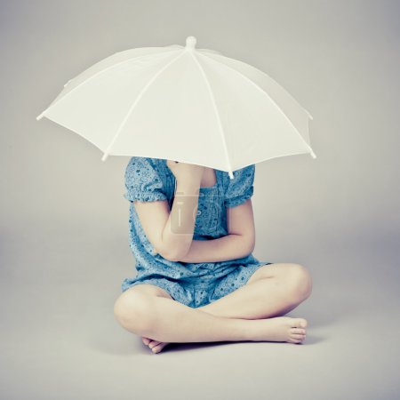 Funny little girl with umbrella