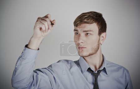 Portrait of thoughtful businessman wlth pen in hand