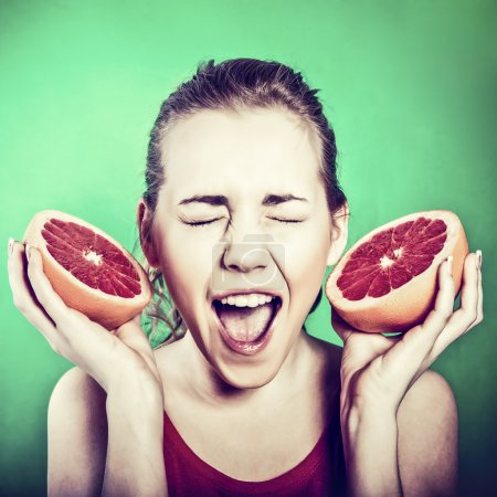 Crazy girl with a grapefruit