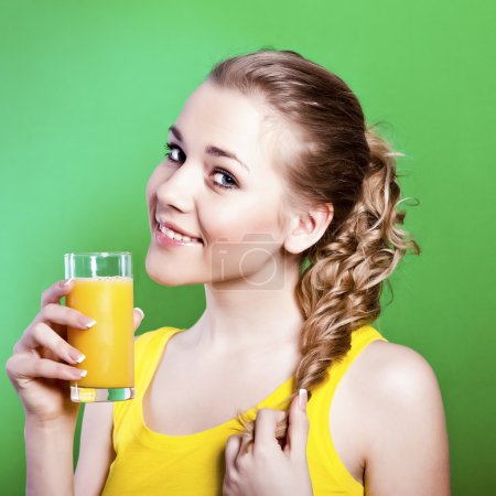 Young happy girl with orange juice in her hands