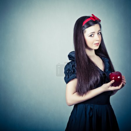 Portrait of a beautiful girl with an apple