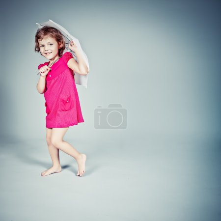 Little Girl standing with umbrella