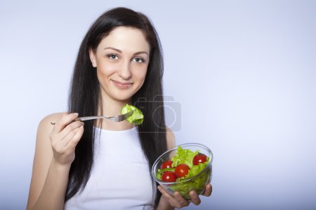Portrait of attractive smiling woman eating salat