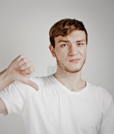 Young man shows thumb down