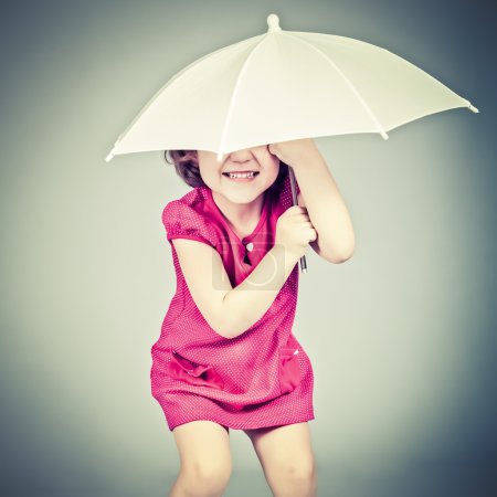Funny little girl with umbrella