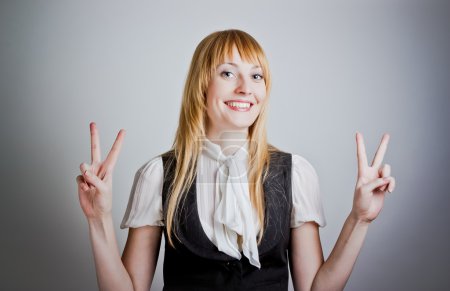 Cute business woman showing the peace