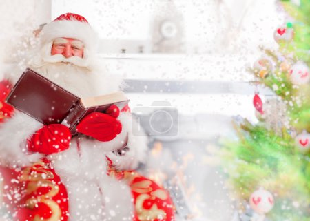 Santa sitting at the Christmas tree, near fireplace and reading