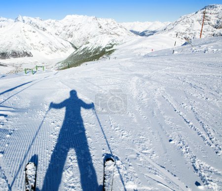 A shadow of ready to go downhill skier