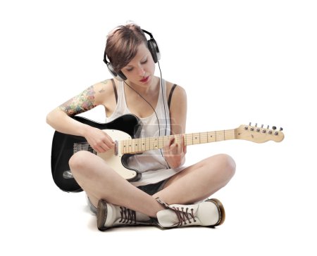 Isolated beautiful woman playing the electric guitar