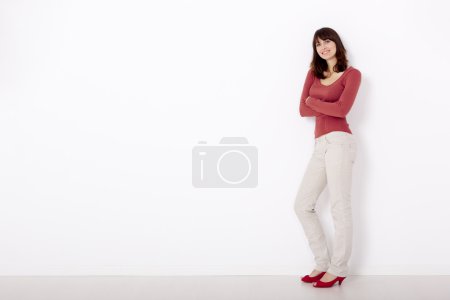 Woman against a white wall