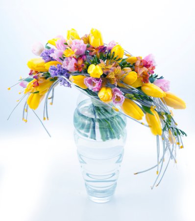 Fresh festive bouquet of flowers in glass vase