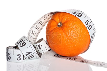 Dieting concept, orange with measuring tape