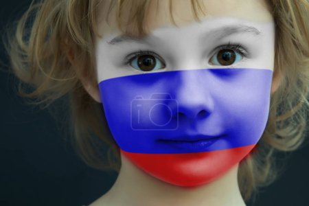 Portrait of a child with a painted Russian flag