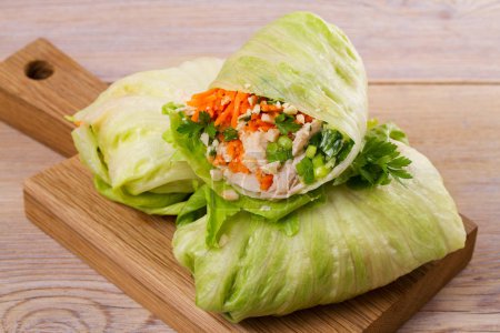 Lettuce wraps with chicken, carrot, peanuts and ginger-scallion oil,