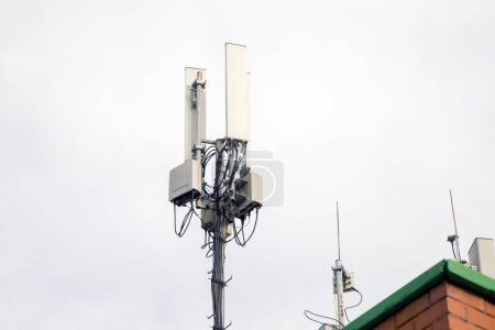Telecommunication tower of 4G andcellular tower of 5G on the roof of a residential building. Radio tower with 5G network