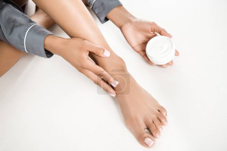 woman applying body cream