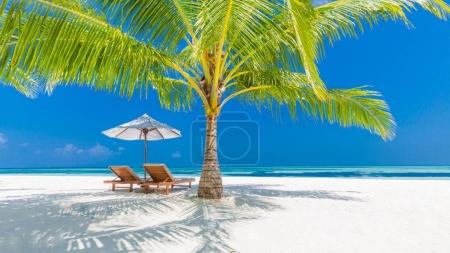 Beautiful beach. Chairs on the sandy beach near the sea. Summer holiday and vacation concept. Inspirational tropical beach. Tranquil scenery, relaxing beach, tropical landscape design. Moody landscape
