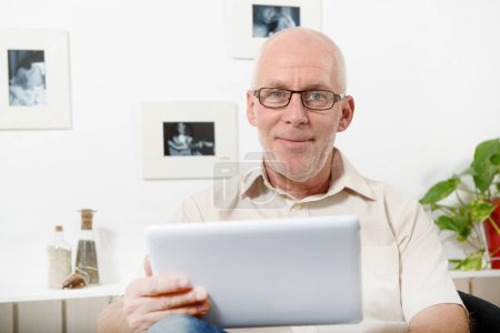 handsome mature man using tablet