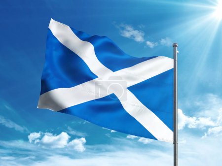 Scottish flag waving in the blue sky
