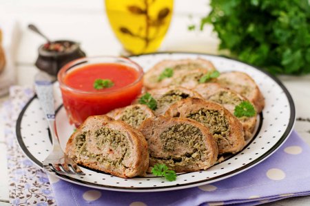 Roll of chicken minced meat with broccoli and tomato sauce.