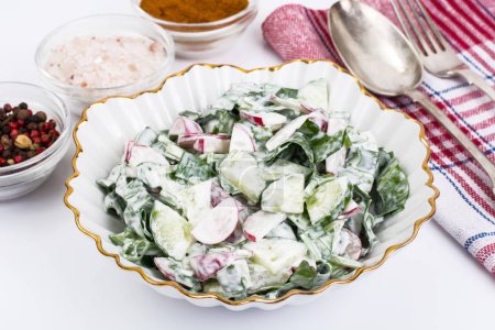Light dietary salad from fresh vegetables with yogurt.
