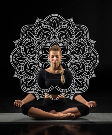 Young woman sitting and meditating