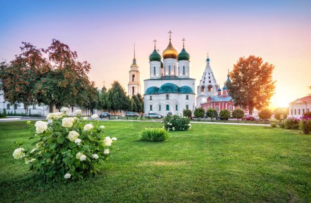 View of the Assumption Cathedral, Tikhvin Church of the Kolomna Kremlin and flower meadow on a sunny summer evening