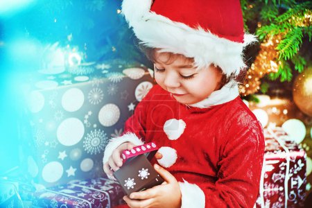 Little santa kid checking the gift