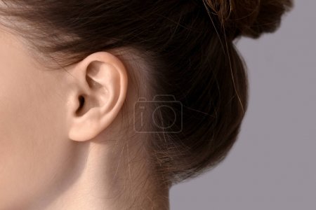 Young woman with hearing problem, closeup