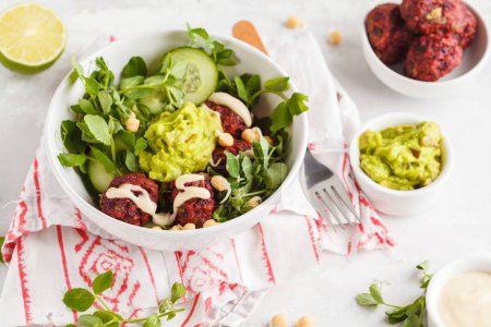 Green vegetable vegan salad with beets meatballs, Guacamole 