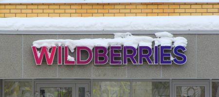 15.02.2020 Syktyvkar, Russia, signboard wildberries covered snow on wall a residential building. Stock photo with empty space for text and design.