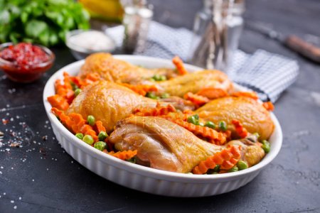 baked chicken legs with spices and vegetables