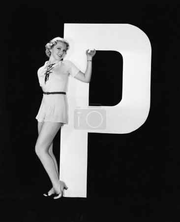 Woman posing with huge letter P