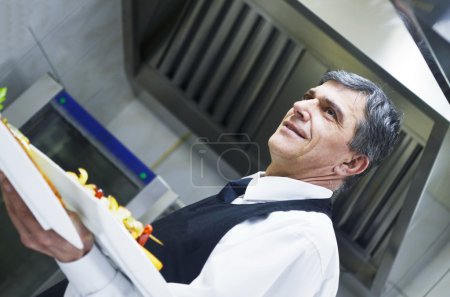 Male chef presenting food