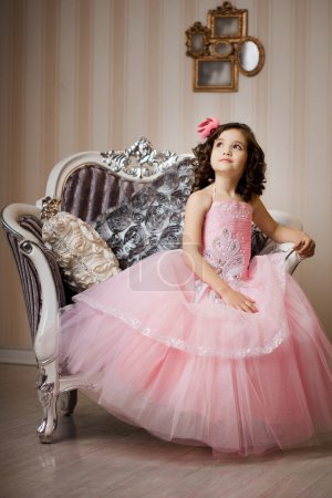 Child on a chair in a nice dress