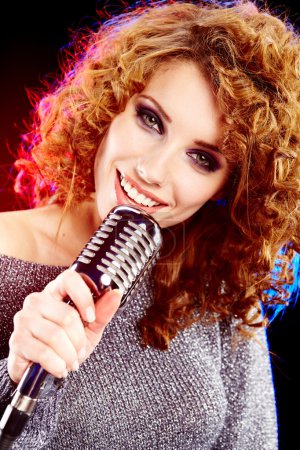 Woman holding a retro microphone