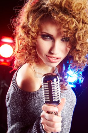 Woman holding a retro microphone
